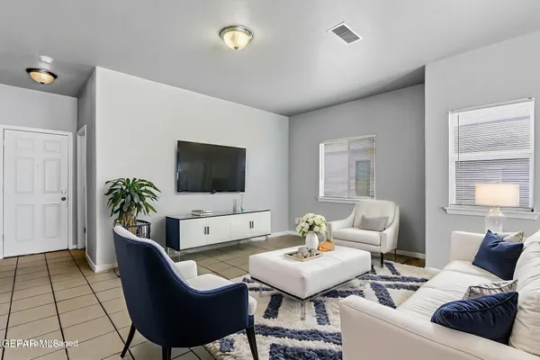 a living room with furniture and a flat screen tv