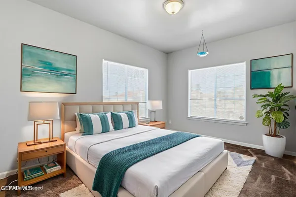 a bedroom with a bed and a potted plant