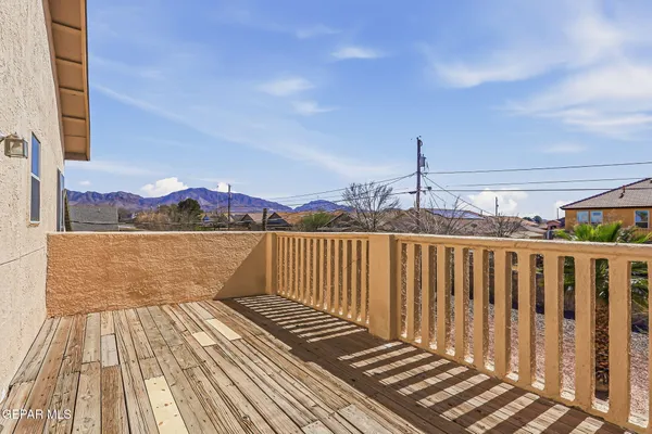 a view of balcony with wooden floor and fence