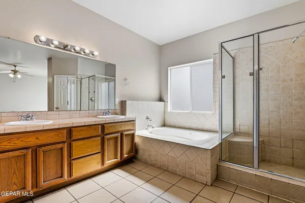 a spacious bathroom with a double vanity sink shower and a mirror
