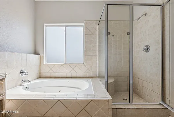 a bathroom with a bathtub and shower