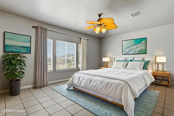 a bedroom with a bed and a painting on the wall