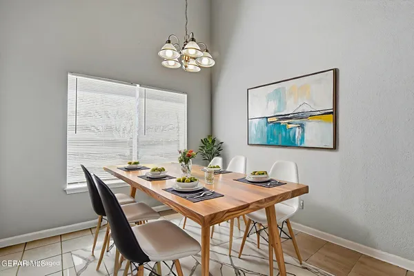 a view of a dining room with furniture a chandelier and wooden floor