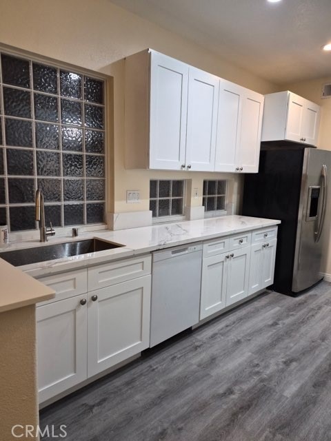 20 Altezza Irvine, CA 92606 - Photo 11 of 11 a kitchen with a sink dishwasher a refrigerator and cabinets
