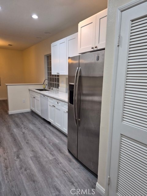 20 Altezza Irvine, CA 92606 - Photo 8 of 11 a kitchen with white cabinets and stainless steel appliances