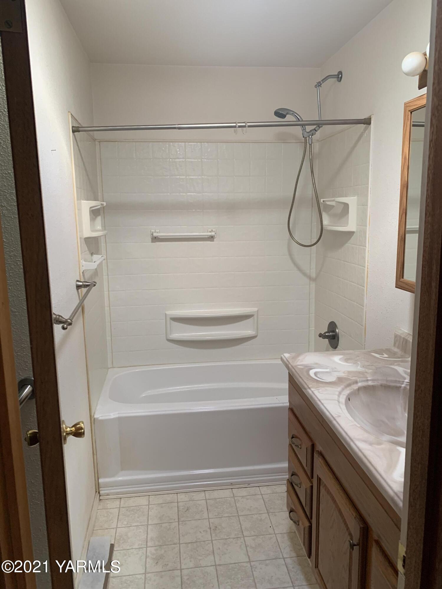 6807 Bell Road Yakima, WA 98901 - Photo 4 of 13 a bathroom with a sink a vanity and shower