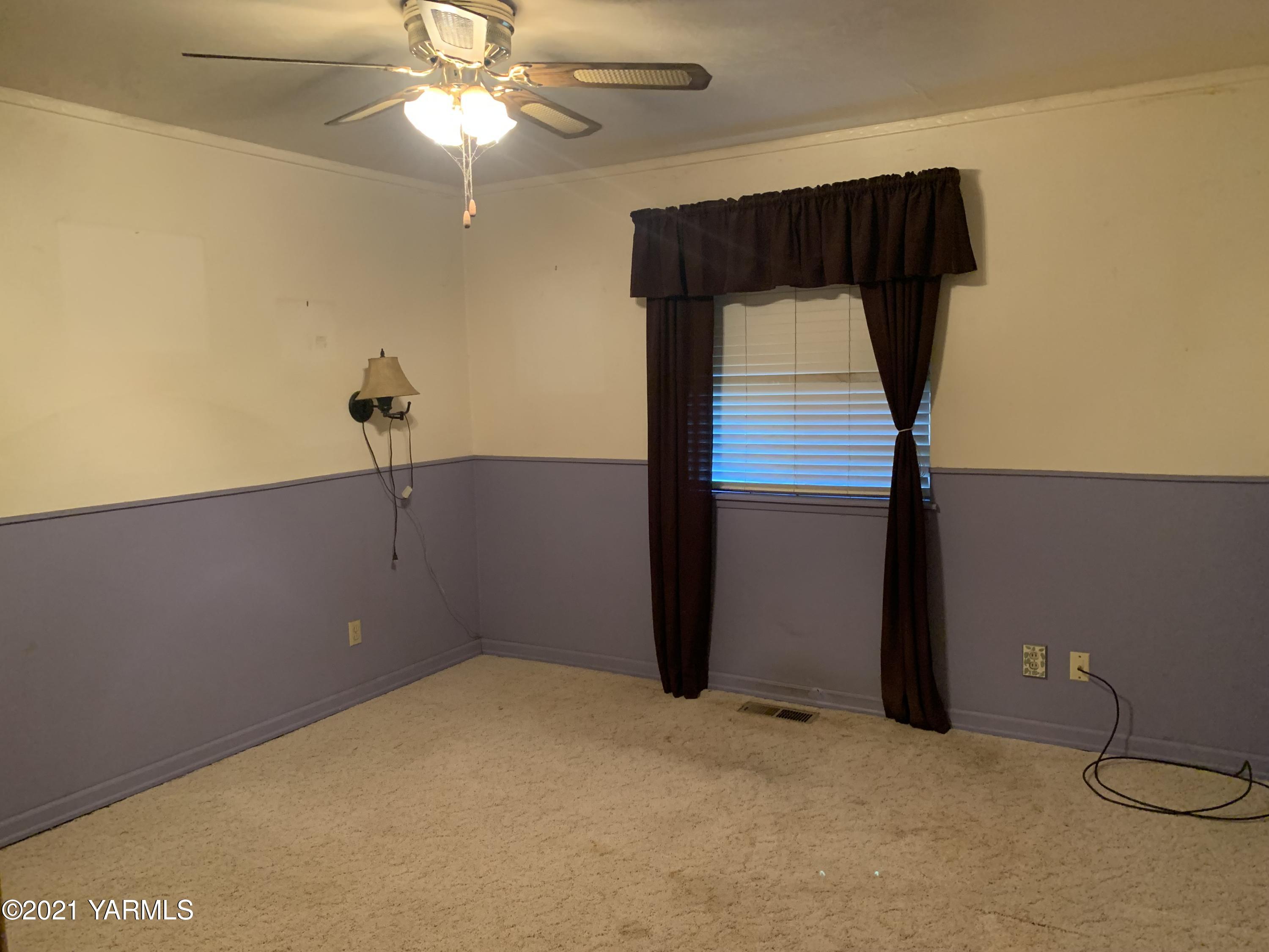 6807 Bell Road Yakima, WA 98901 - Photo 5 of 13 a view of a room with a ceiling fan and a carpet