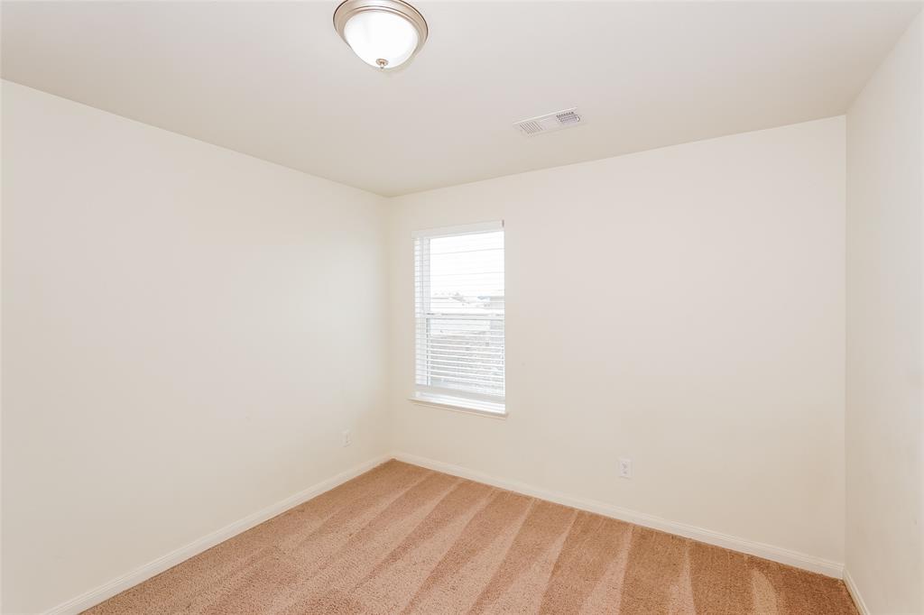 113 Rebel Road Venus, TX 76084 - Photo 12 of 17 a view of an empty room with wooden floor and a window