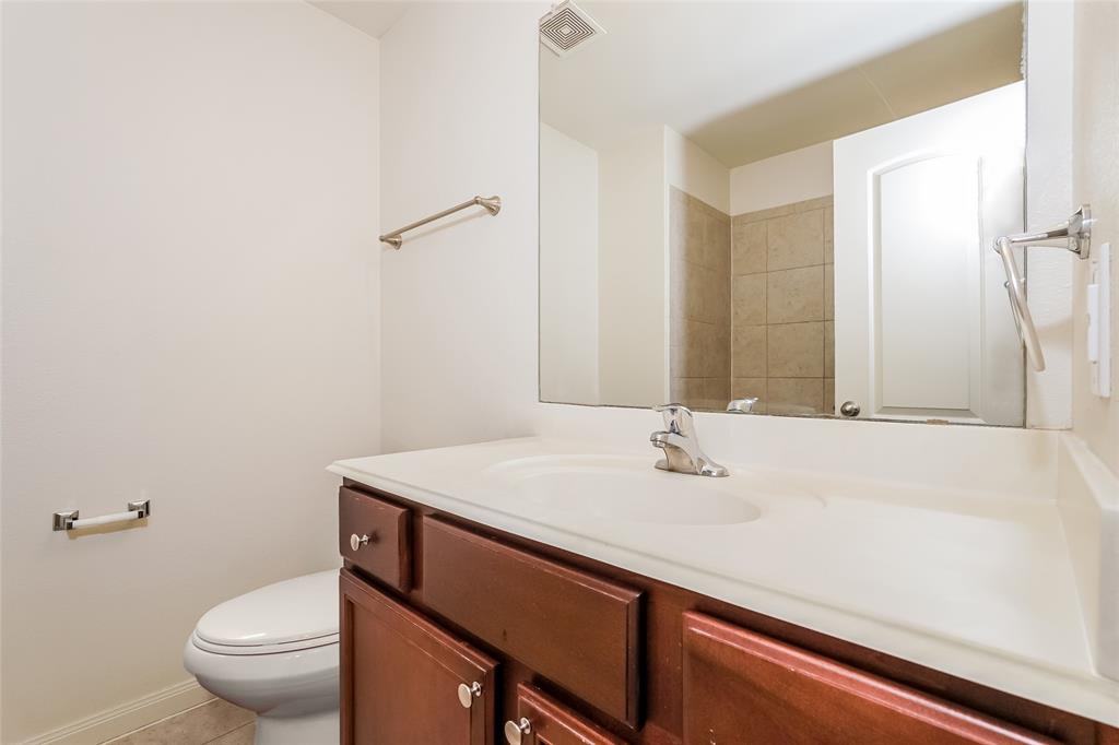 113 Rebel Road Venus, TX 76084 - Photo 13 of 17 a bathroom with a sink a toilet and a mirror