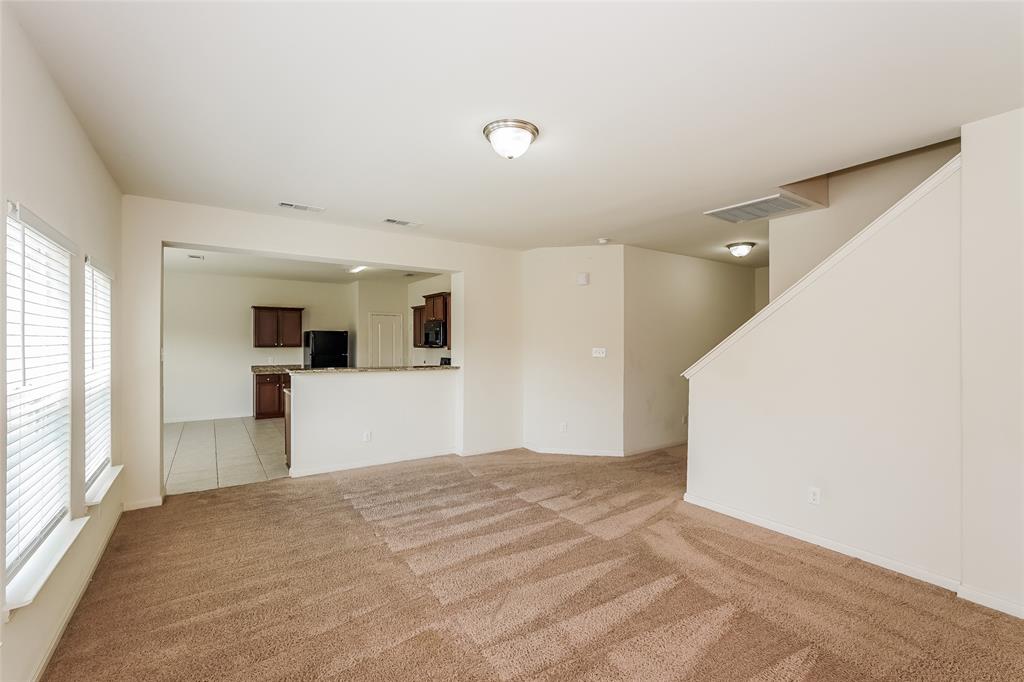 113 Rebel Road Venus, TX 76084 - Photo 2 of 17 a view of a big room with wooden floor and windows