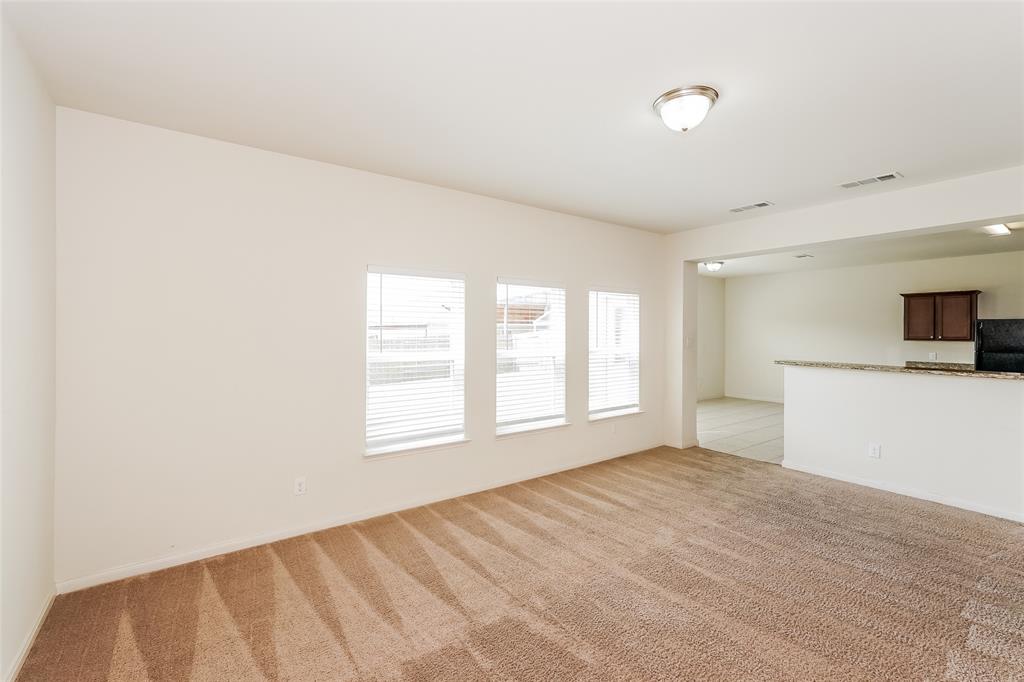 113 Rebel Road Venus, TX 76084 - Photo 3 of 17 a view of empty room with wooden floor and fan