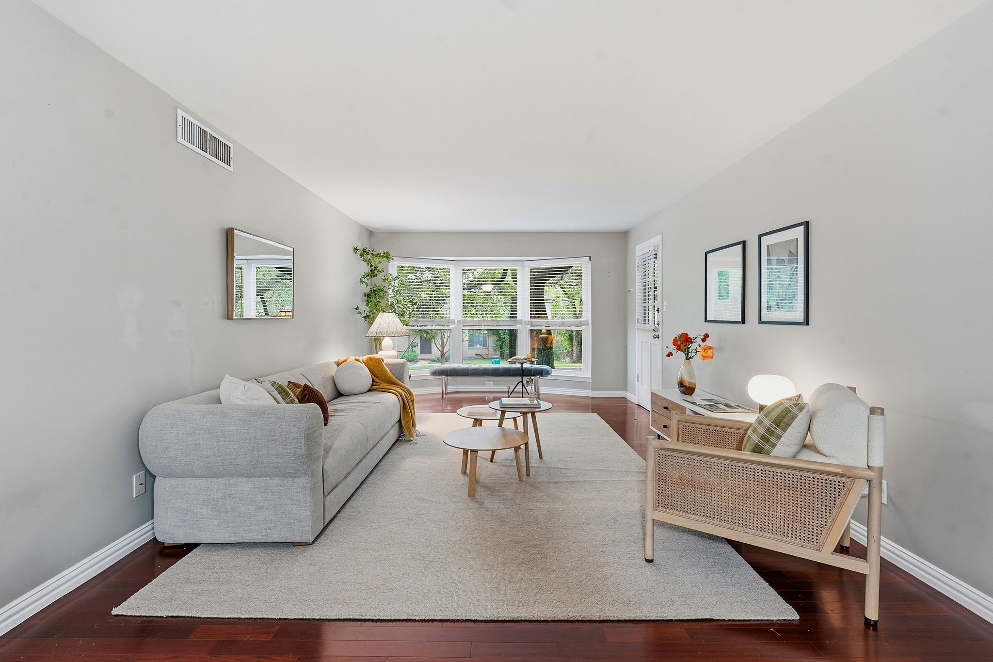 1210 Windsor Road, Unit 104 Austin, TX 78703 - Photo 3 of 29 Hardwood floors and a wide bay window define this inviting living room.
