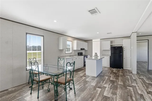 a kitchen with a table and chairs in it