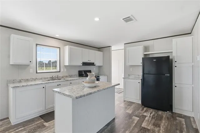 a kitchen with a sink stove and refrigerator
