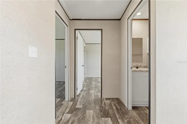 a view of a hallway with wooden floor