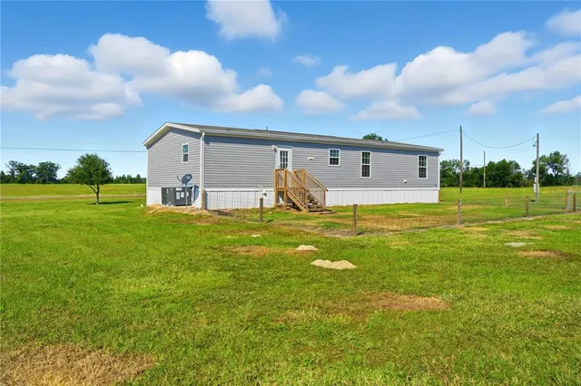 a house view with swimming pool and garden