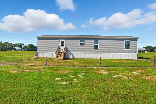 a view of a house with a yard and a garden