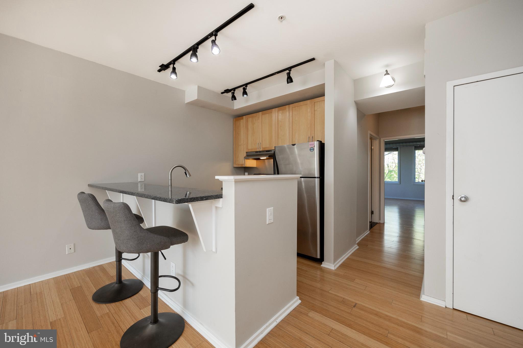 a view of a kitchen with furniture and wooden floor