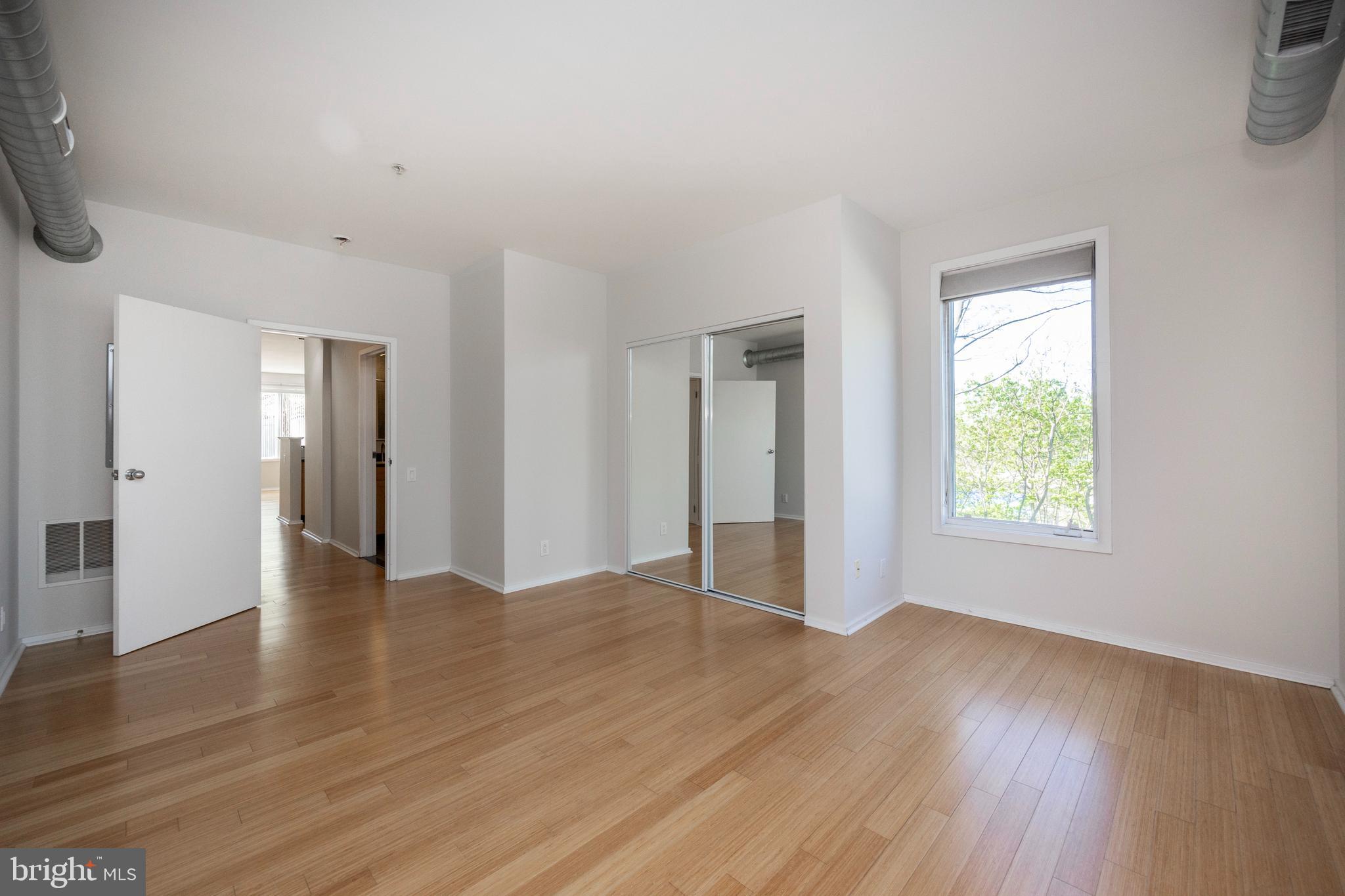 182 Gay Street, Unit 502 Philadelphia, PA 19128 - Photo 12 of 21 a view of an empty room with wooden floor and a window