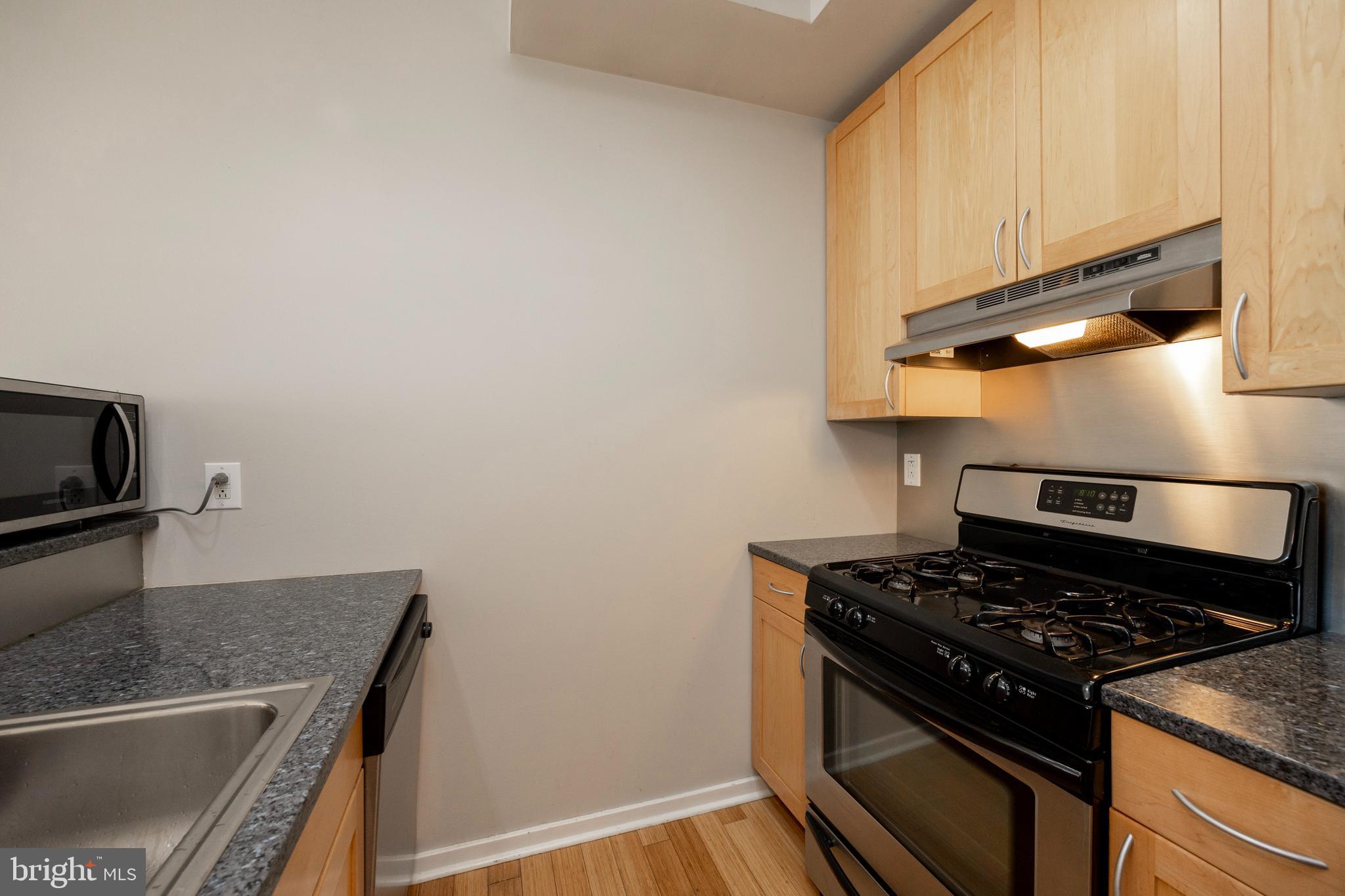 182 Gay Street, Unit 502 Philadelphia, PA 19128 - Photo 4 of 21 a stove top oven sitting inside of a kitchen