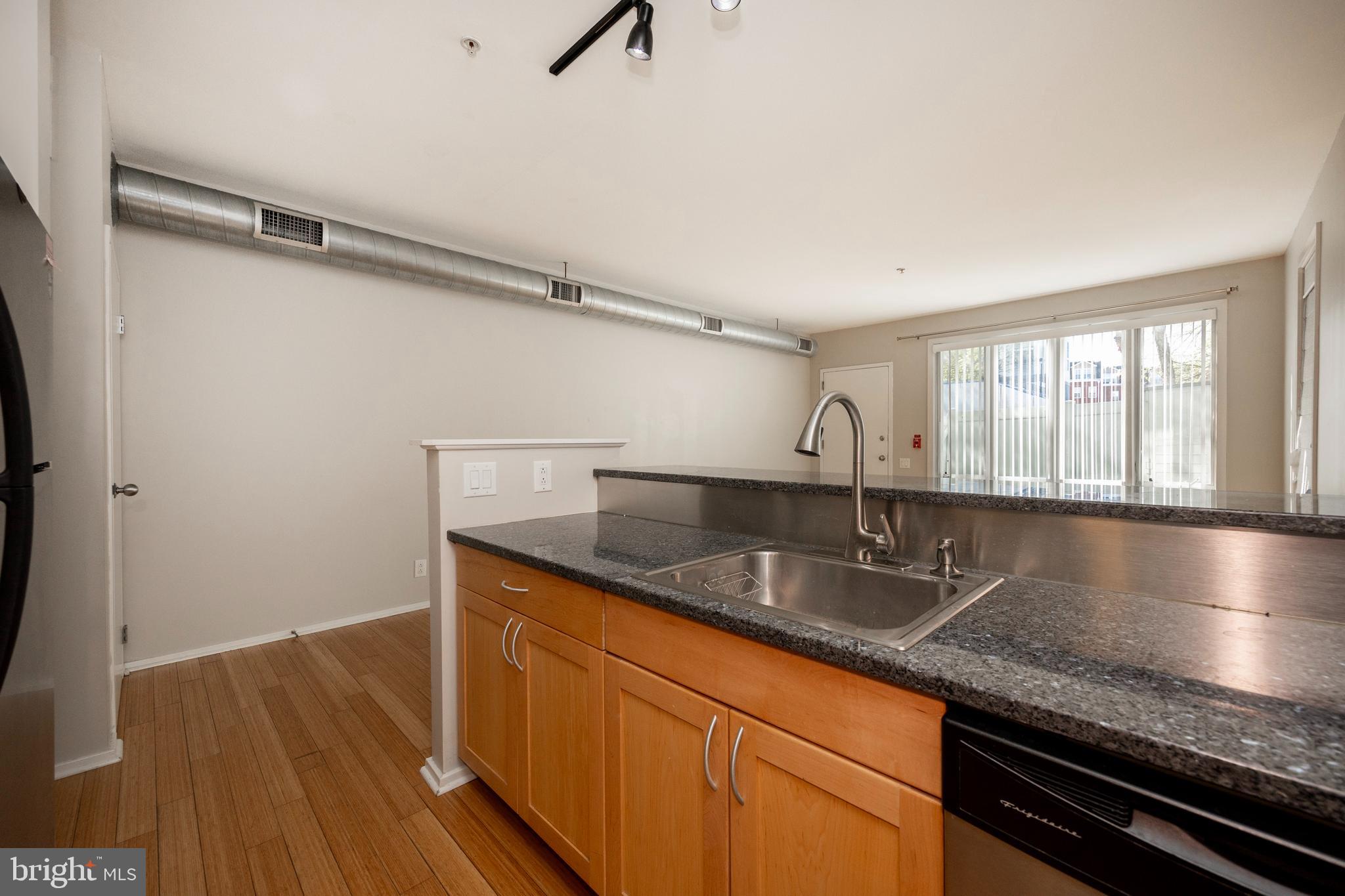 182 Gay Street, Unit 502 Philadelphia, PA 19128 - Photo 6 of 21 a kitchen with granite countertop a sink and a window
