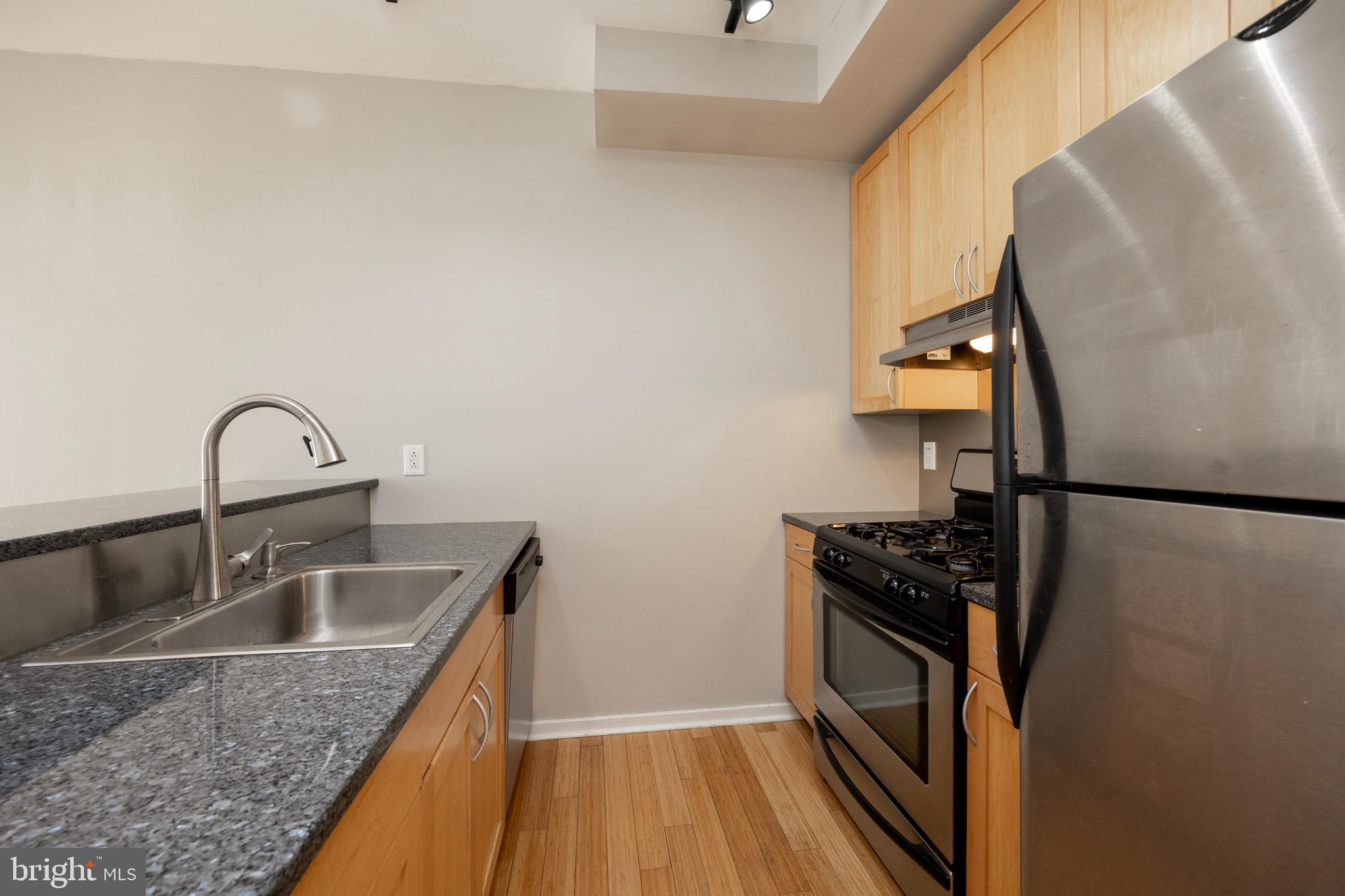 182 Gay Street, Unit 502 Philadelphia, PA 19128 - Photo 7 of 21 a kitchen with sink refrigerator and stove