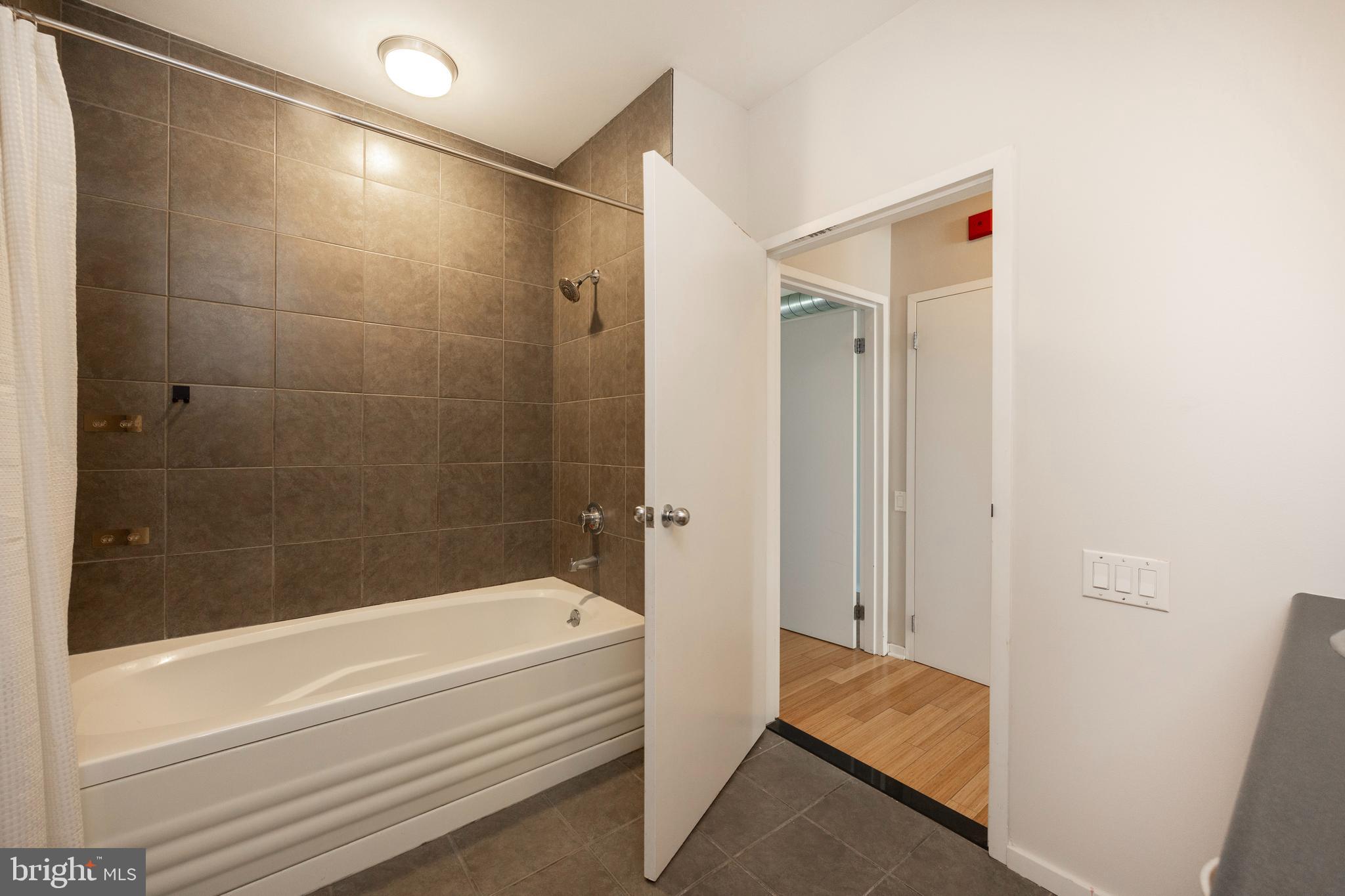 182 Gay Street, Unit 502 Philadelphia, PA 19128 - Photo 10 of 21 a bathroom with a bathtub and a shower