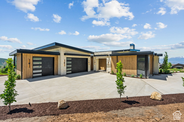 741 Sunny Ridge Lane Salem, UT 84653 - Photo 1 of 1 Contemporary home with concrete driveway, a garage, and a chimney