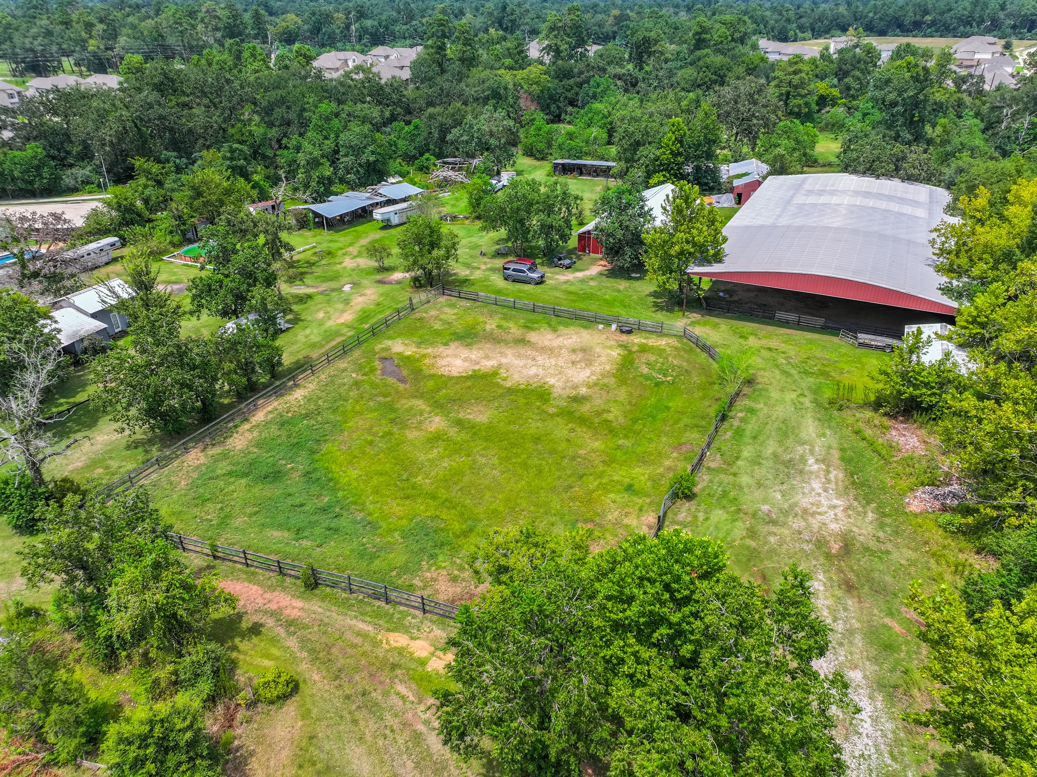 25635 Hufsmith Cemetery Road Tomball, TX 77375 - Photo 25 of 50 This elevated perspective captures the full natural character of this Tomball acreage — verdant fields, mature tree canopies along the perimeter, and existing improvements providing an immediate foundation for whatever exciting chapter lies ahead. Opportunities of this scale and quality simply do not come available very often in the Greater Houston market.