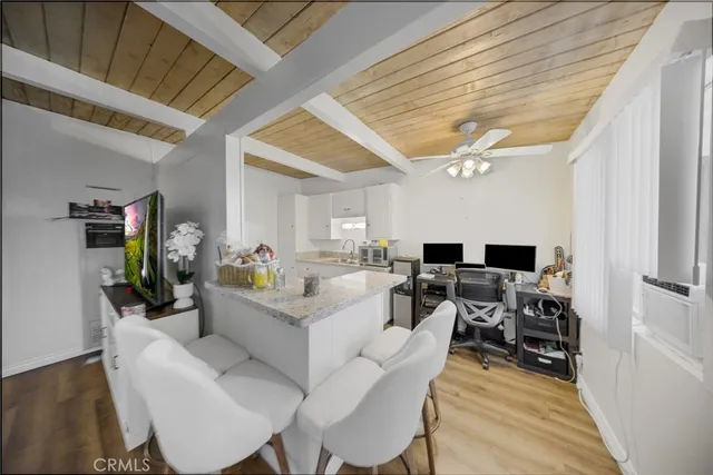 a living room with furniture a dining table and wooden floor