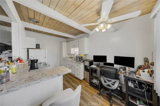 a view of a workspace with furniture and a kitchen
