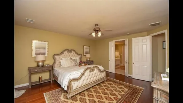 a spacious bedroom with a bed and a chandelier