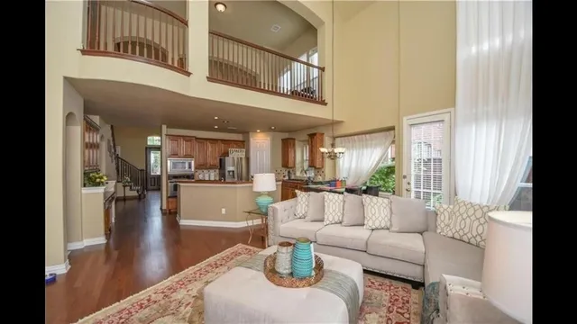 a living room with fireplace furniture and a large window