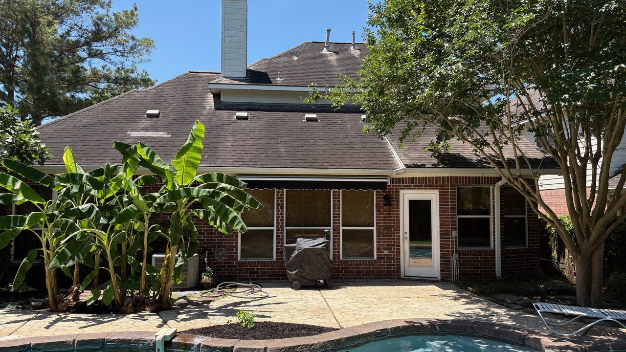 22402 Rue Canyon Court Katy, TX 77450 - Photo 17 of 18 This wide-angle view showcases how beautifully the home integrates with its outdoor surroundings. Flagstone-style pathways weave effortlessly through the grass, connecting the massive patio deck to the rest of the yard. With a back door leading directly into the main living spaces, this outdoor retreat serves as a true extension of the home.
