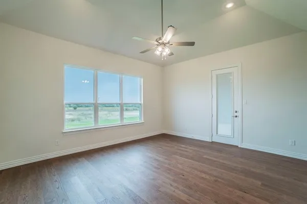 a view of an empty room with wooden floor