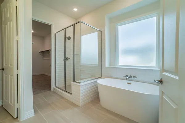 a bathroom with double vanity sinks and a shower