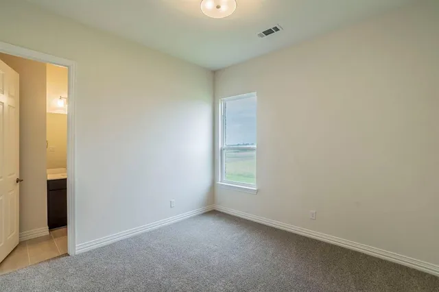 a bathroom with a granite countertop sink toilet and mirror