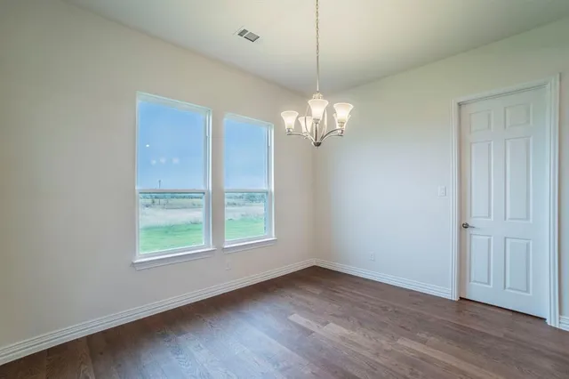a kitchen with stainless steel appliances granite countertop a kitchen island a stove and a sink