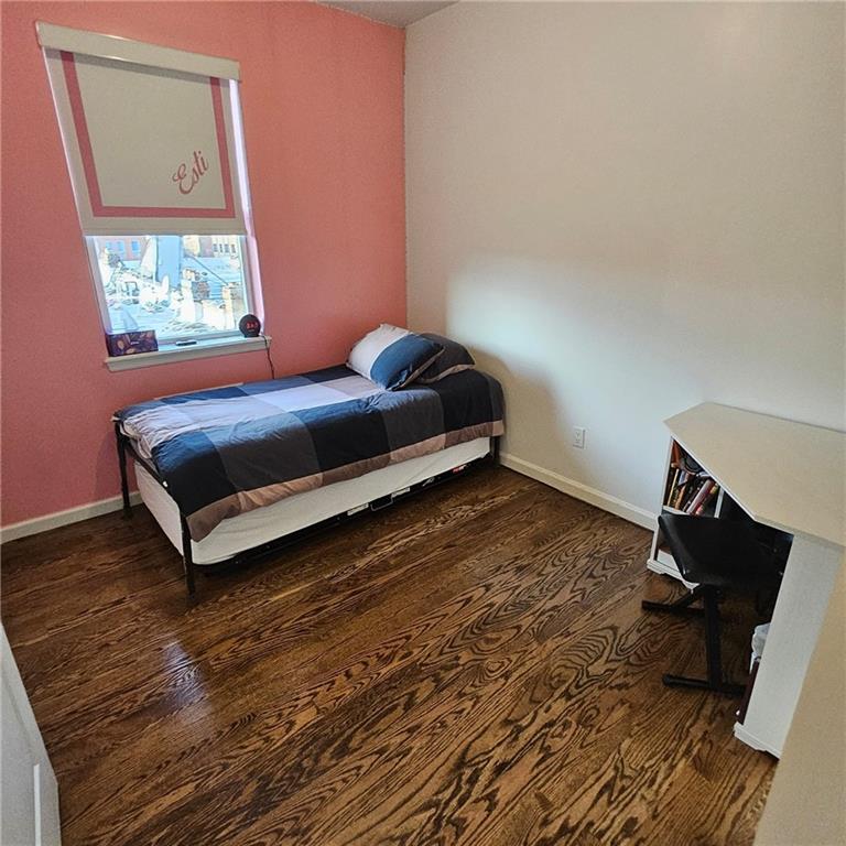 1012 41st Street, Unit 4 Brooklyn, NY 11219 - Photo 11 of 12 a bedroom with a bed and a window