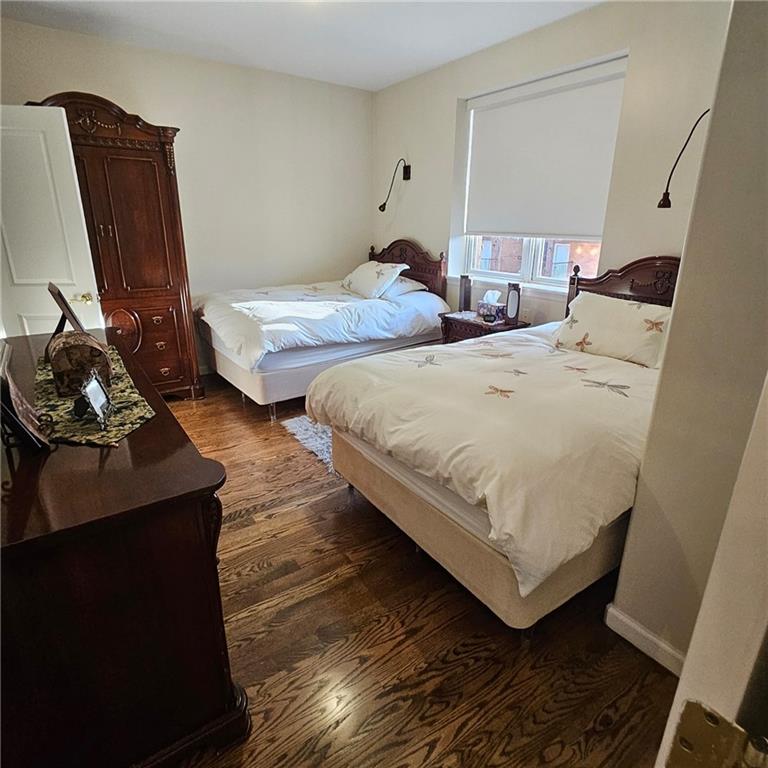 1012 41st Street, Unit 4 Brooklyn, NY 11219 - Photo 7 of 12 a bedroom with two beds and a chair