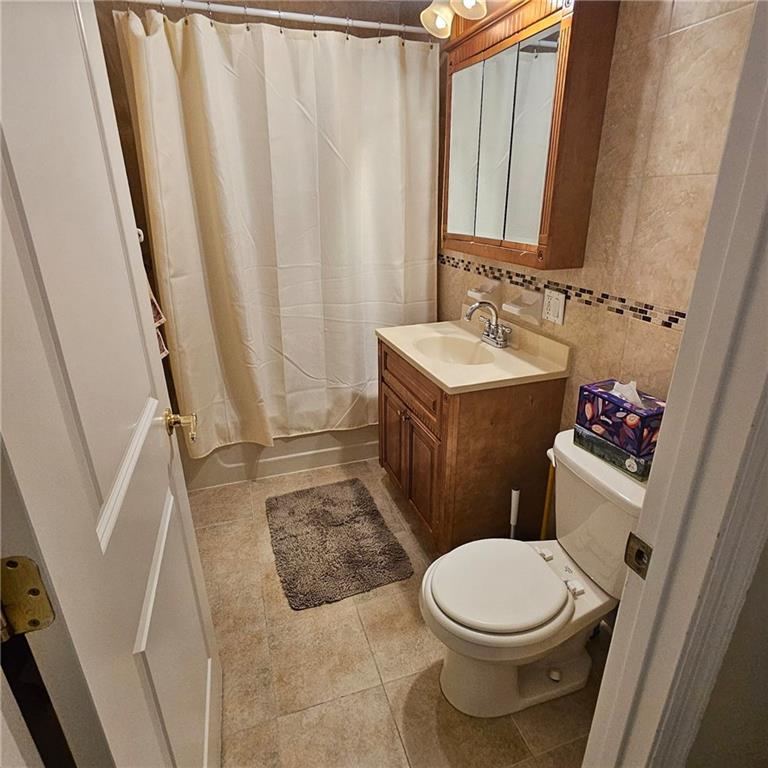 1012 41st Street, Unit 4 Brooklyn, NY 11219 - Photo 8 of 12 a bathroom with a sink and a toilet