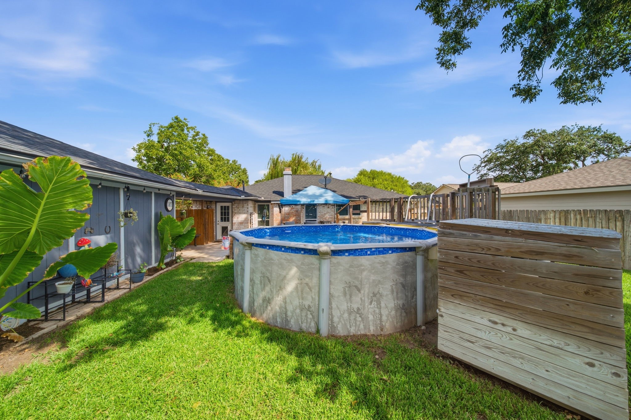 19519 Ricelake Lane Houston, TX 77084 - Photo 33 of 47 Charming backyard with a refreshing above-ground pool and lush greenery, perfect for relaxing and entertaining.