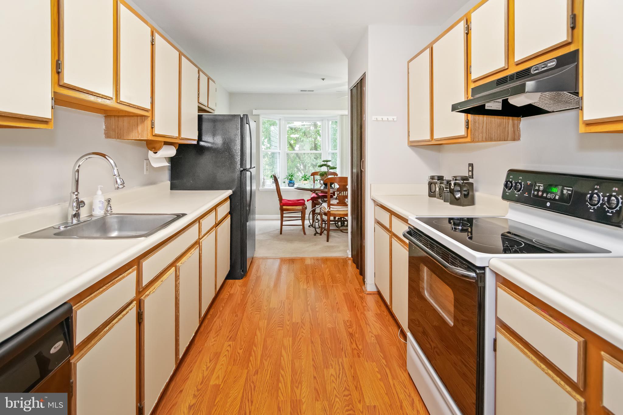 a kitchen with granite countertop a sink a counter top space and stainless steel appliances