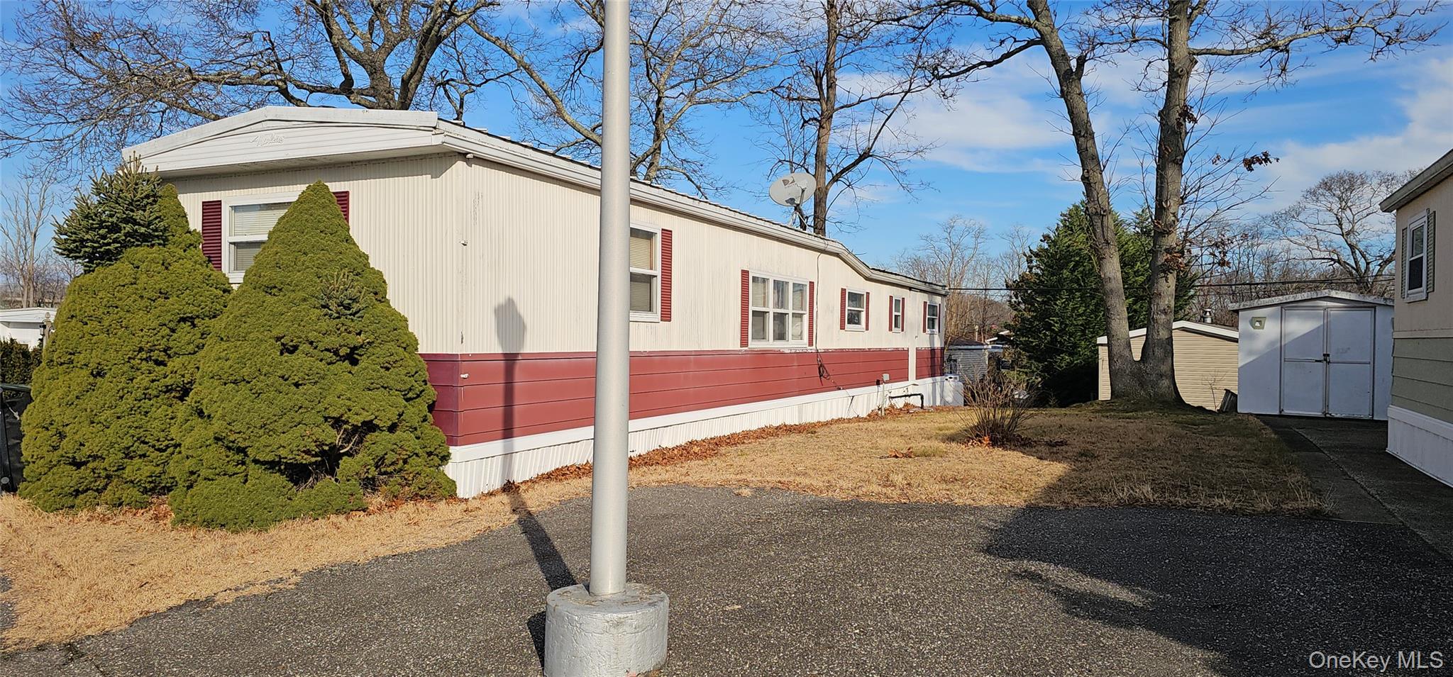 1964 River Road, Unit 35 Calverton, NY 11933 - Photo 2 of 14 View of side of home with a storage unit