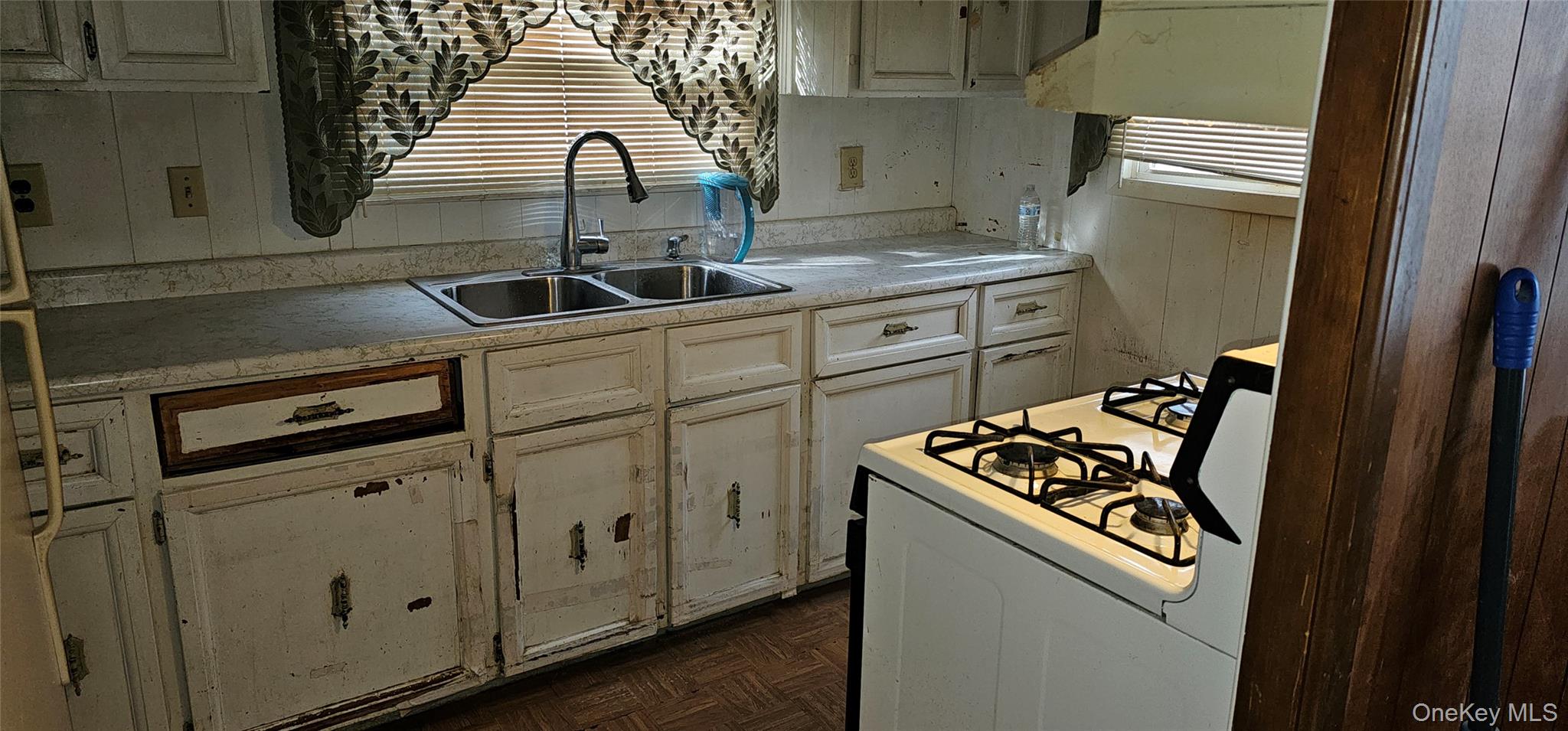1964 River Road, Unit 35 Calverton, NY 11933 - Photo 6 of 16 Kitchen featuring white range with gas stovetop and light countertops