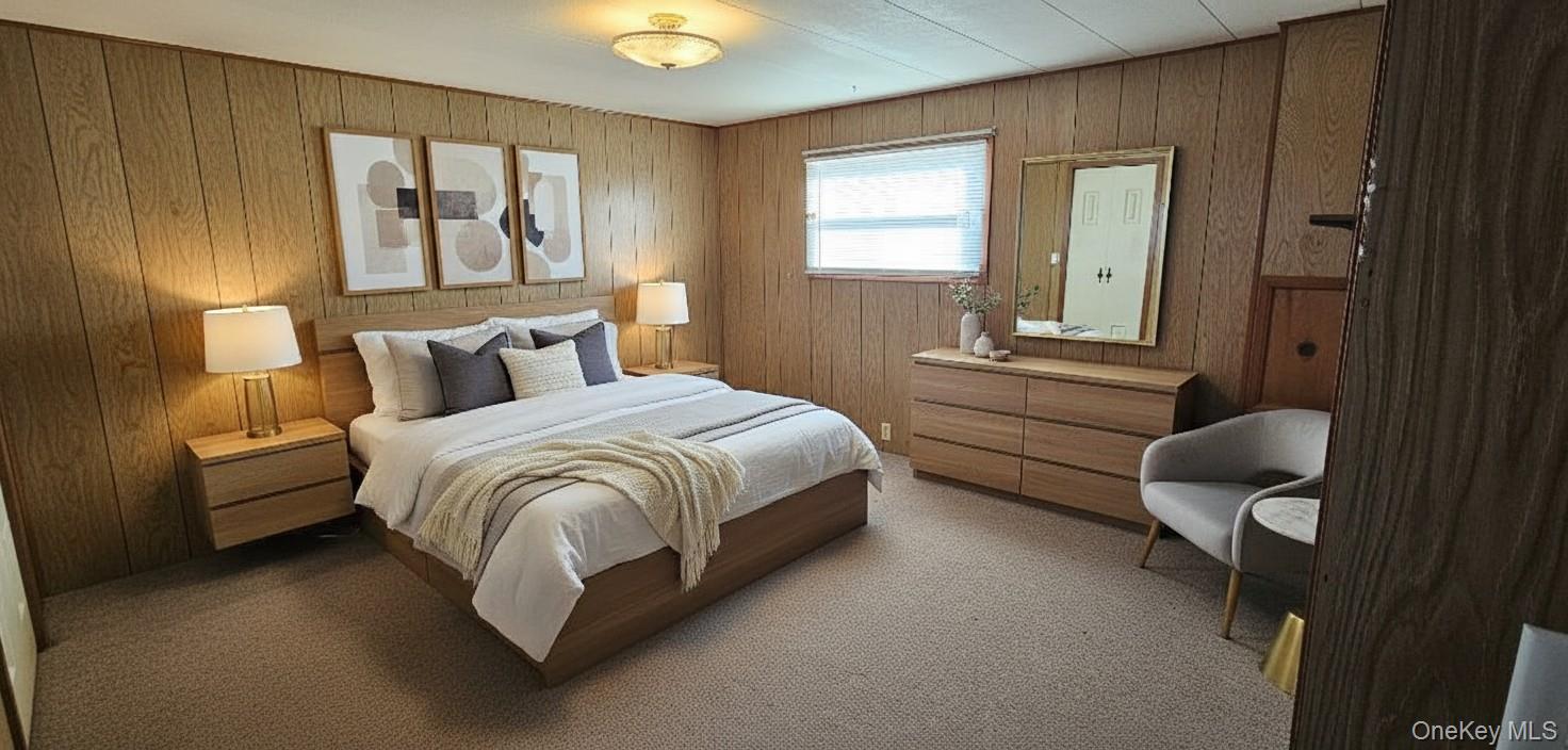 1964 River Road, Unit 35 Calverton, NY 11933 - Photo 8 of 16 Bedroom with wood walls and carpet floors