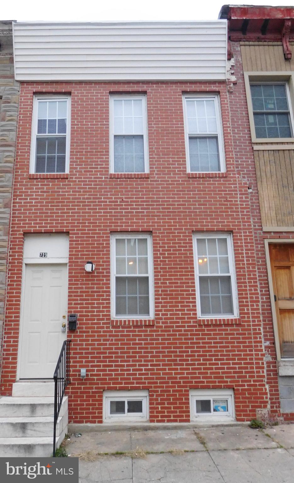 a red brick building that has lot of windows on it