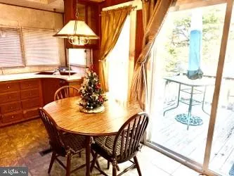 a dining room with furniture window and a chandelier