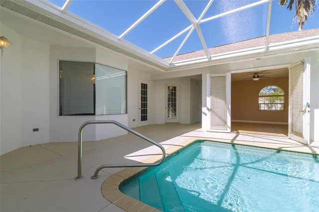 a view of a lake in front of house with outdoor seating