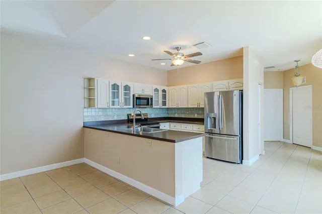 a kitchen with stainless steel appliances granite countertop a sink and refrigerator